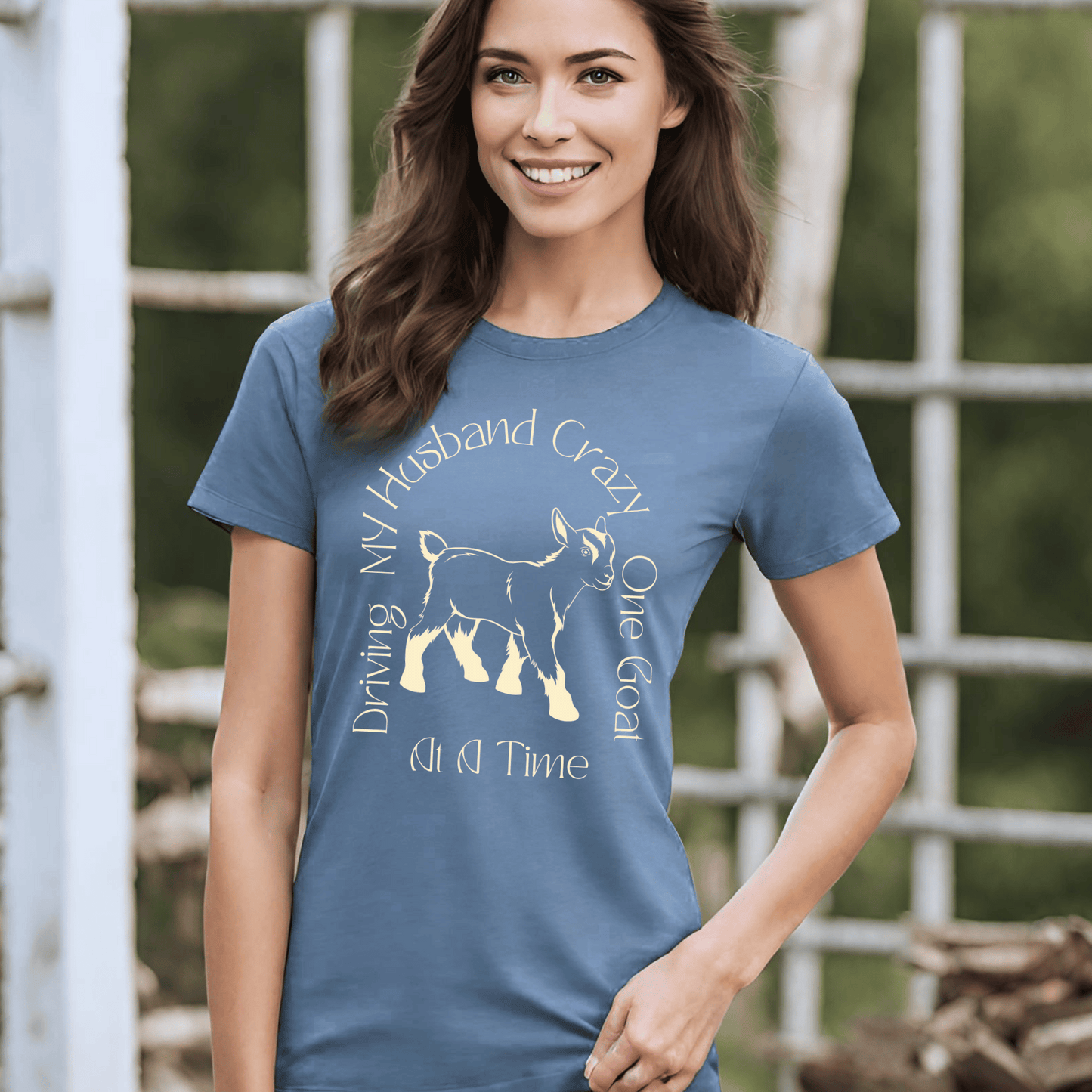 The saying Driving My Husband Crazy One Goat At A Time. with a cute outline of a baby goat on a crew neck t-shirt