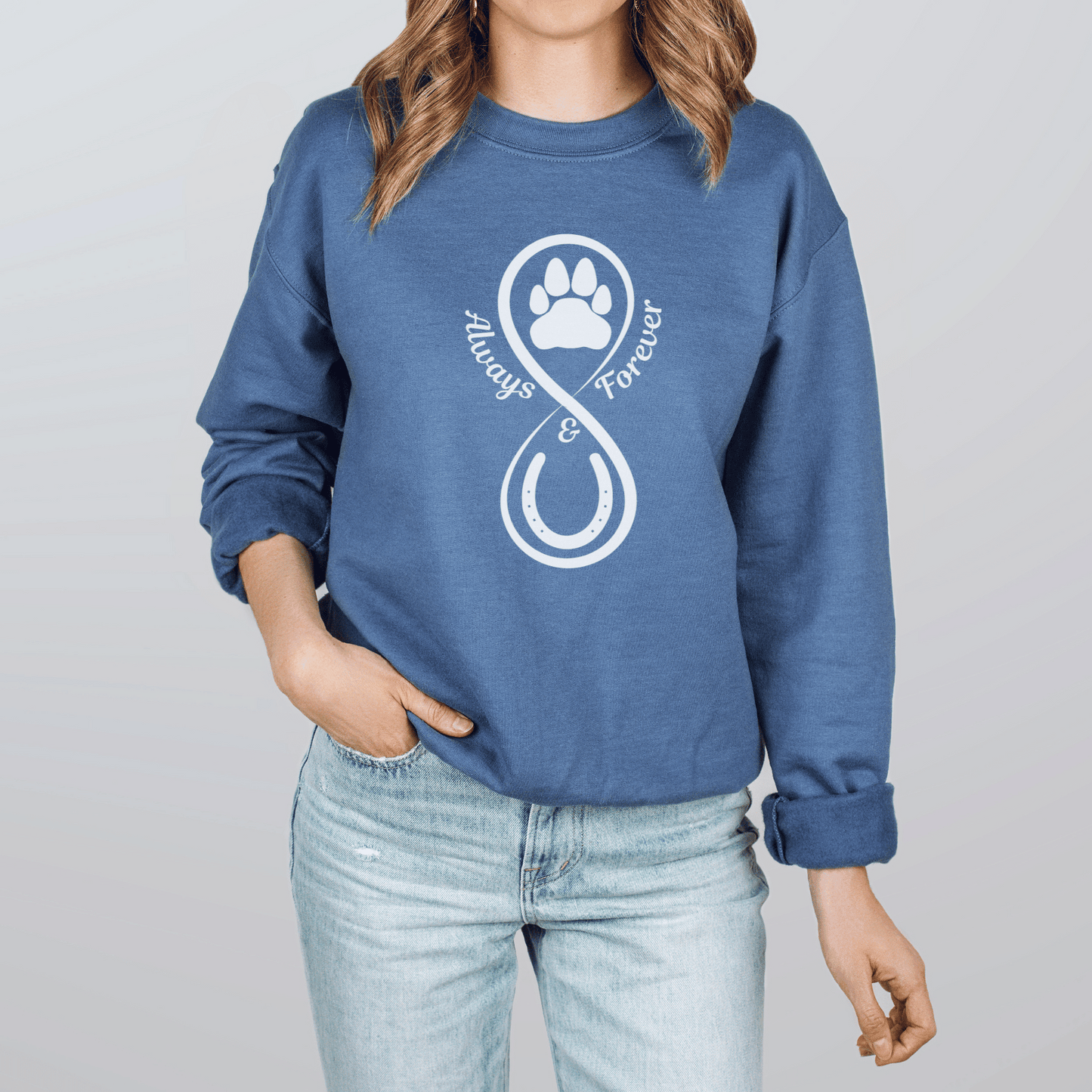 Our Always and Forever Pet Sweatshirt is a must-have for all pet parents! Featuring the words Always and Forever accompanied by an infinity symbol, horse shoe, and paw print, this shirt serves as a beautiful tribute to the treasured memories of your beloved pets.