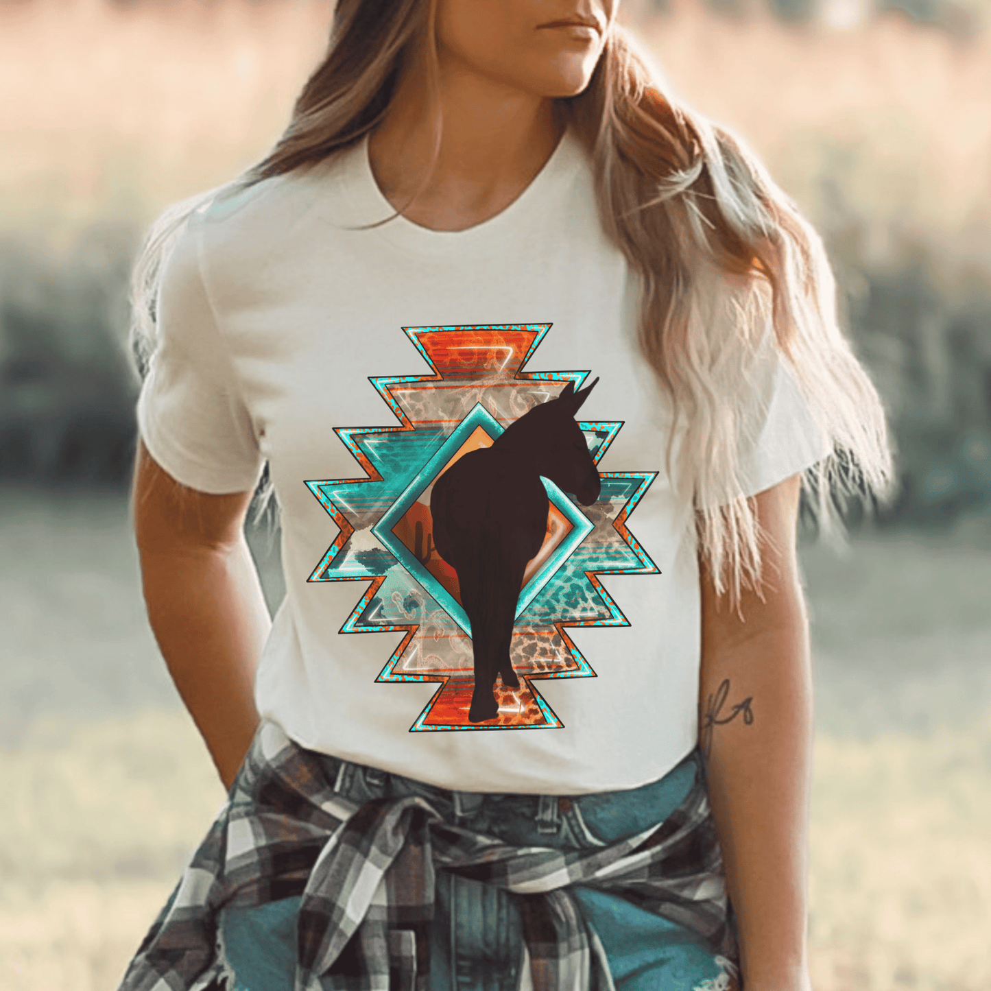 Southwestern-style graphic tee featuring a charming donkey silhouette! This shirt is perfect for animal lovers and those who embrace a farm, ranch, or country lifestyle. If you're a donkey enthusiast, this shirt is a must-have! Show off your love for these adorable animals or surprise a fellow donkey lover with a thoughtful gift from our donkey collection.