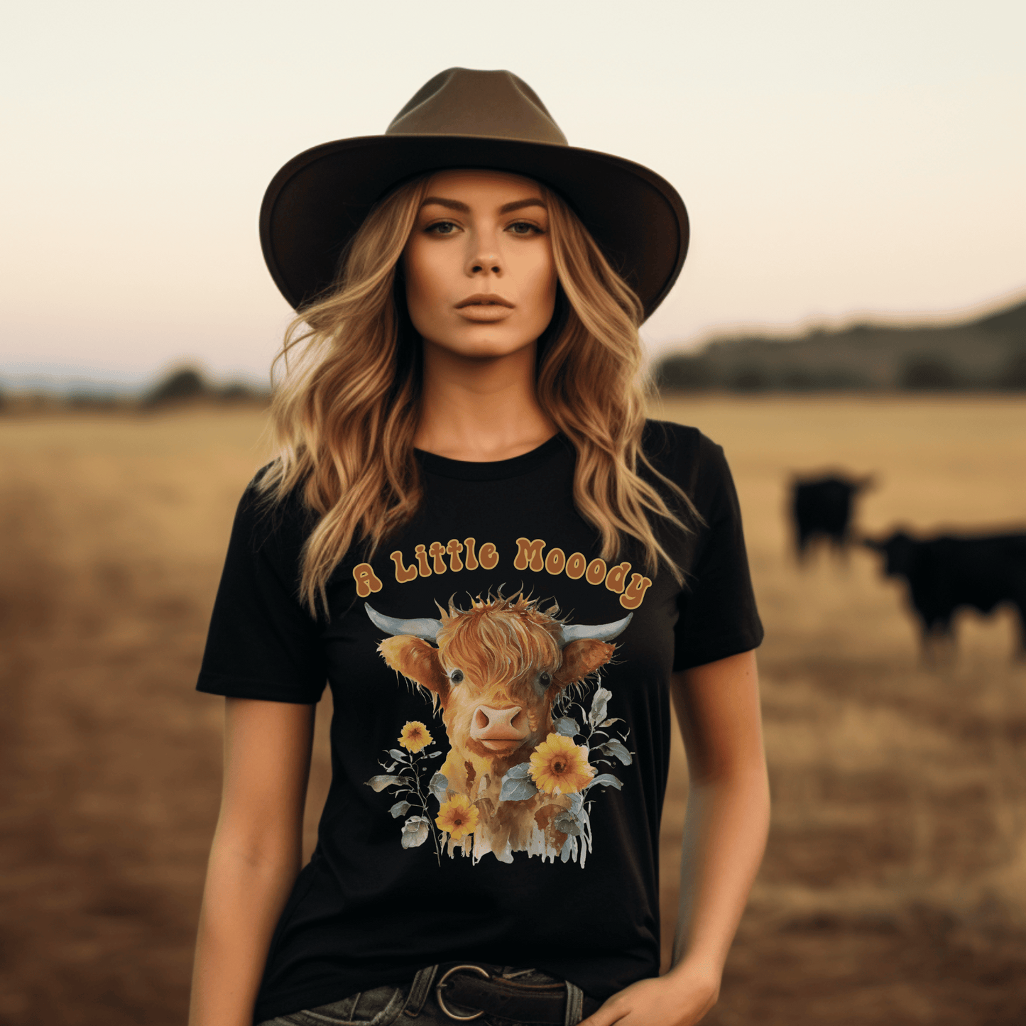 a little moody saying, perfectly complemented by an adorable Highland cow calf and a radiant arrangement of sunflowers on a t-shirt