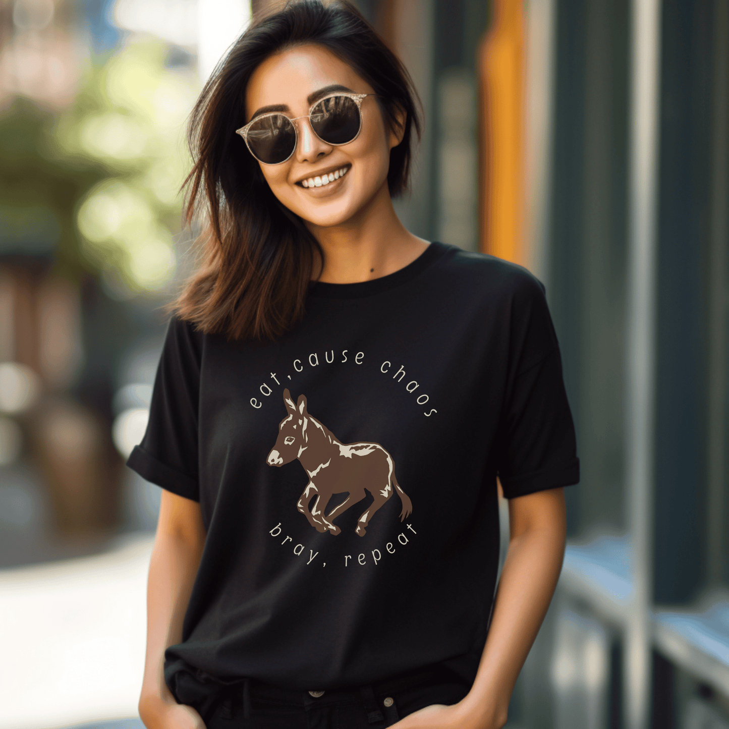 donkey t-shirt featuring a cute donkey design and the fun saying eat, cause chaos, bray, repeat. This whimsical and charming tee is perfect for donkey lovers