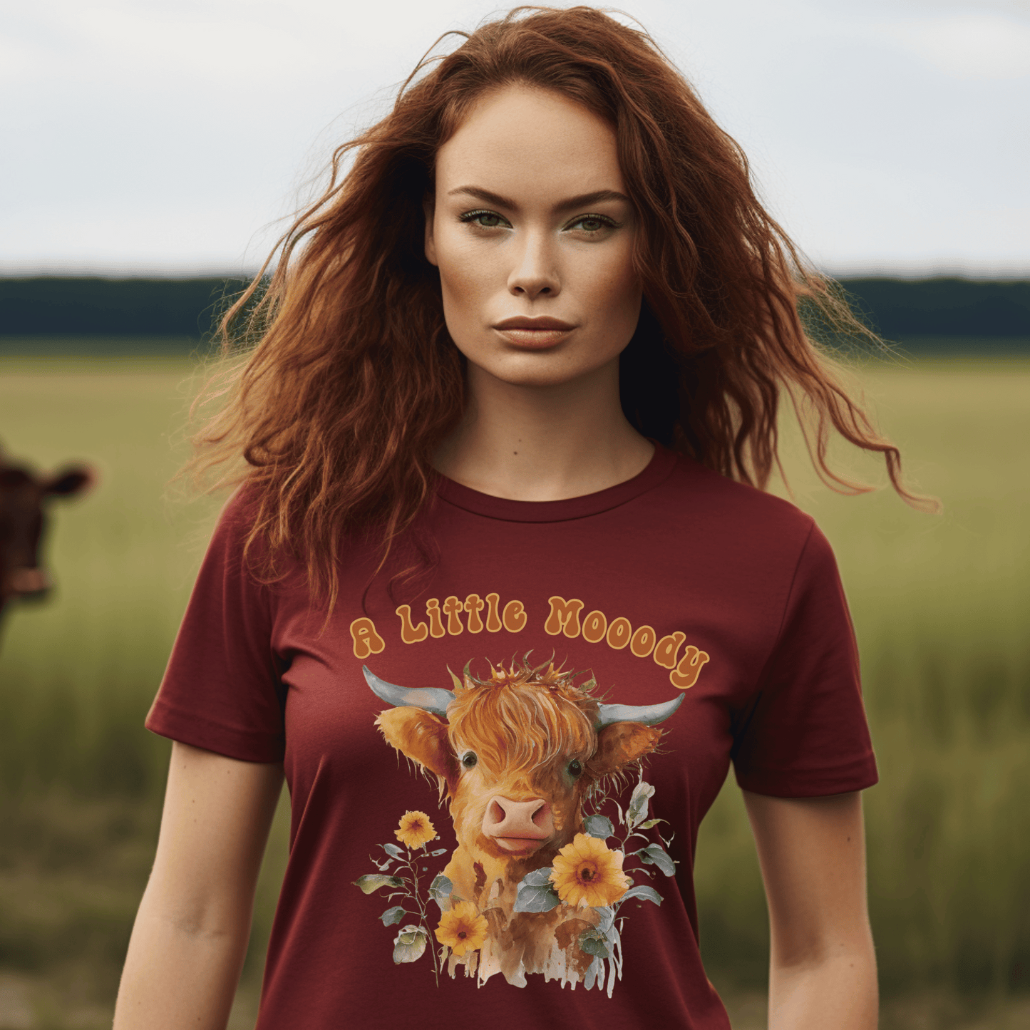 a little moody saying, perfectly complemented by an adorable Highland cow calf and a radiant arrangement of sunflowers on a t-shirt