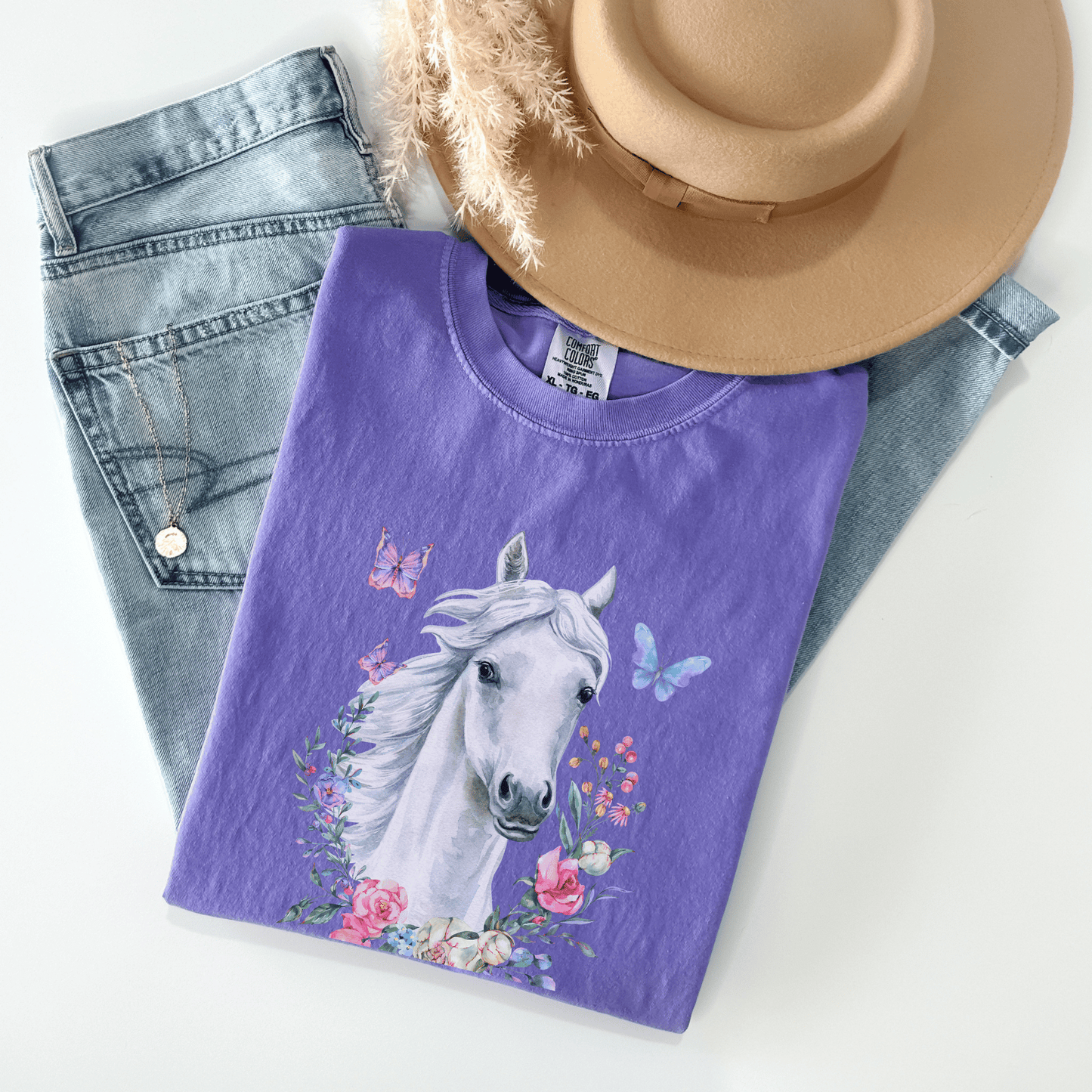 White Horse Boho Cowgirl t-shirt with a stunning cottagecore design featuring floral and butterflies in pastel colors. Made with high-quality materials, this shirt is both stylish and comfortable, perfect for any occasion. Whether you're dressing up for a night out or keeping it casual, this t-shirt is sure to turn heads