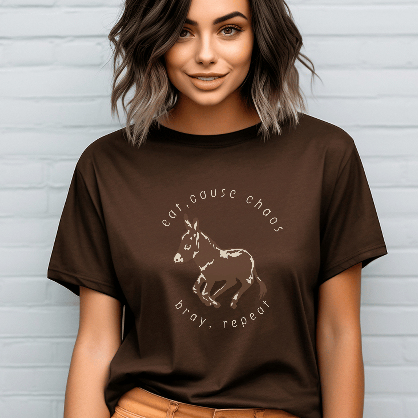 donkey t-shirt featuring a cute donkey design and the fun saying eat, cause chaos, bray, repeat. This whimsical and charming tee is perfect for donkey lovers