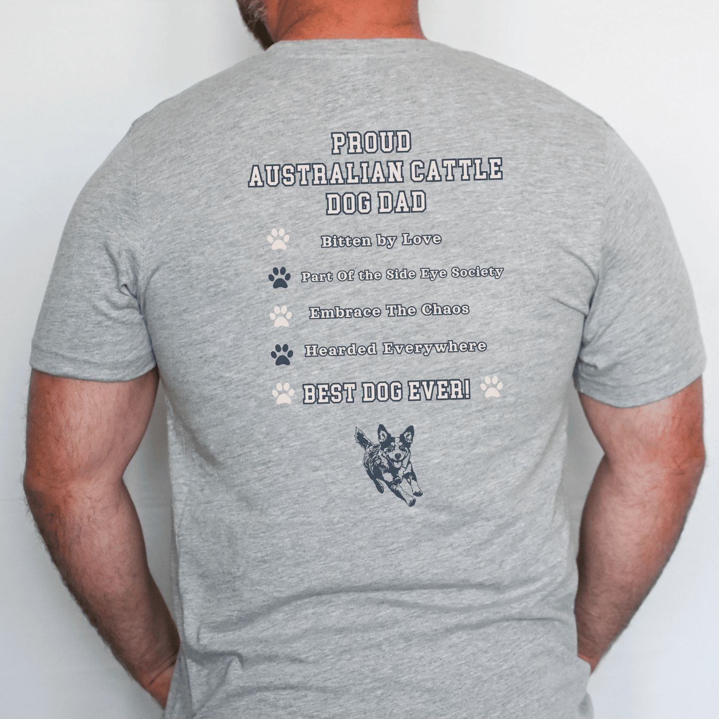 Gray t-shirt with text and a dog illustration on the back, worn by a person.