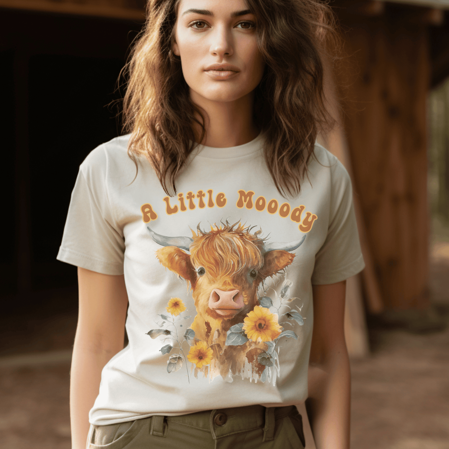 a little moody saying, perfectly complemented by an adorable Highland cow calf and a radiant arrangement of sunflowers on a t-shirt