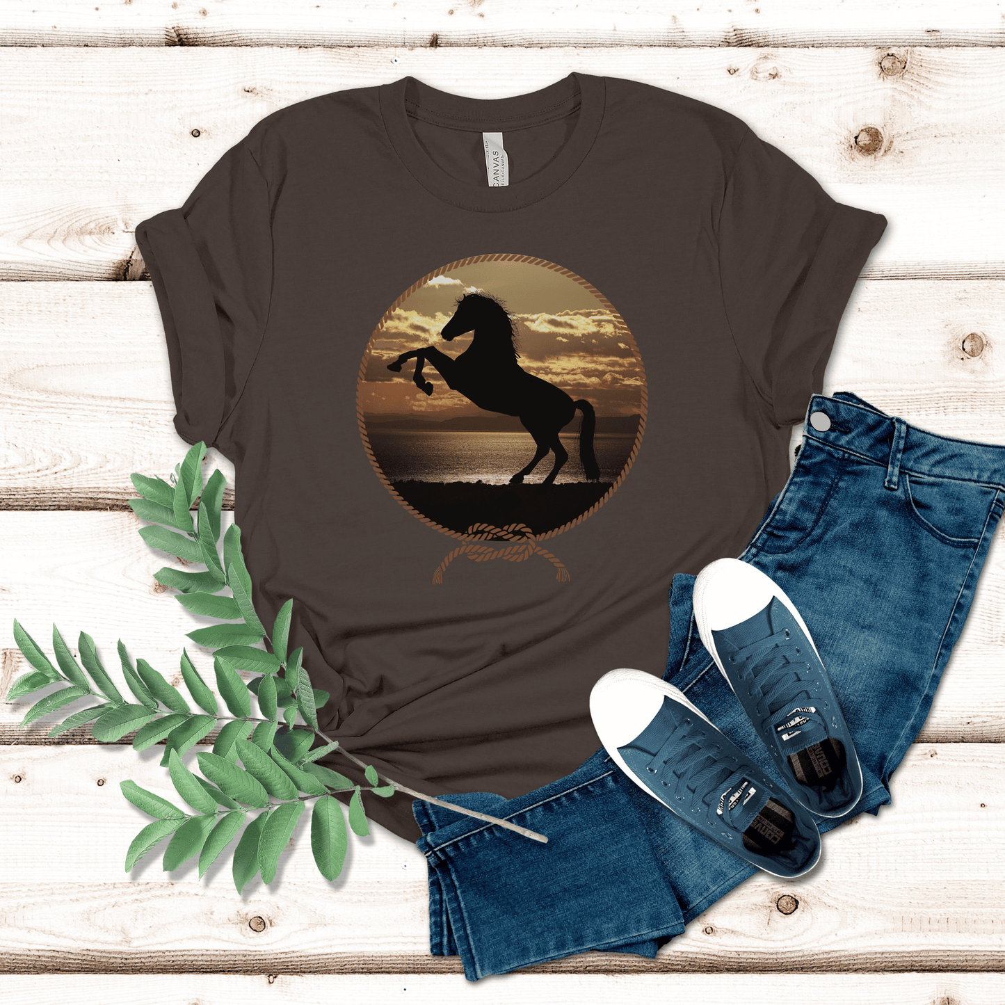Experience the beauty of the wild west with this Rearing Horse at the Beach tee. Featuring a majestic rearing horse against a stunning backdrop of sun, sand, and surf at sunset, this unique design brings a bold western vibe to any look. Be the envy of the town!