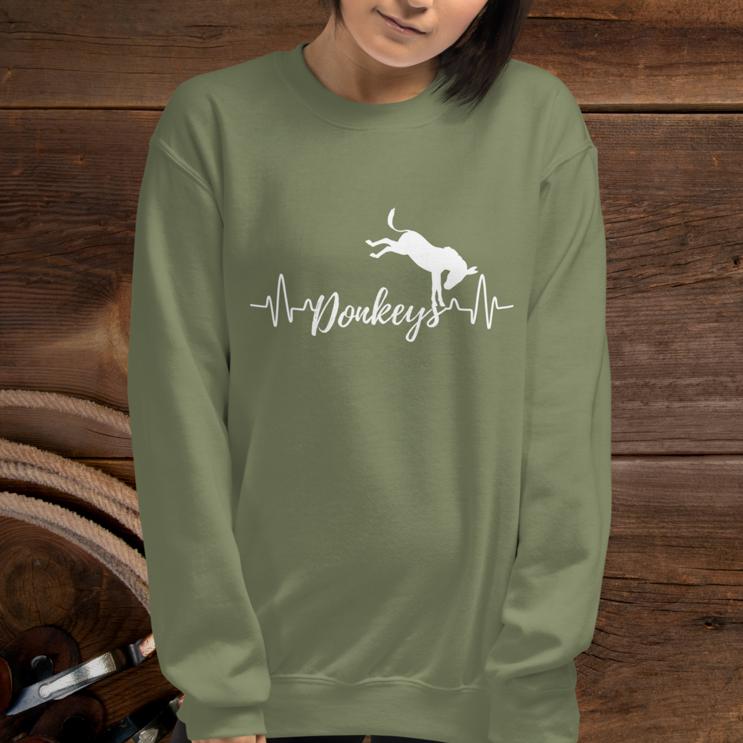 Military Green crew neck sweatshirt with a heart beat design with the word Donkeys in the middle of the heartbeat, with a silhouette of a bucking donkey above it.