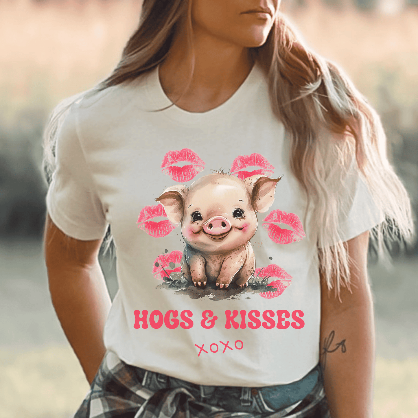 Look no further than this cute pig t-shirt that says "Hogs and Kisses". Whether you're a pig lover or just want to make a playful statement, this t-shirt is the perfect choice. Crafted from top-quality material, this shirt is both durable and comfortable, making it perfect for any occasion. So go ahead and add some fun to your wardrobe with this fun and flirty pig t-shirt.