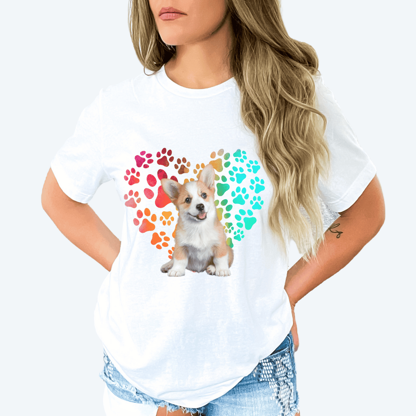 This Corgi Dog t-shirt features a paw print heart in the background, making it a unique and thoughtful gift for dog lovers, pet owners, and Corgi moms. The shirt is perfect for anyone who wants to show off their love for their furry friend.