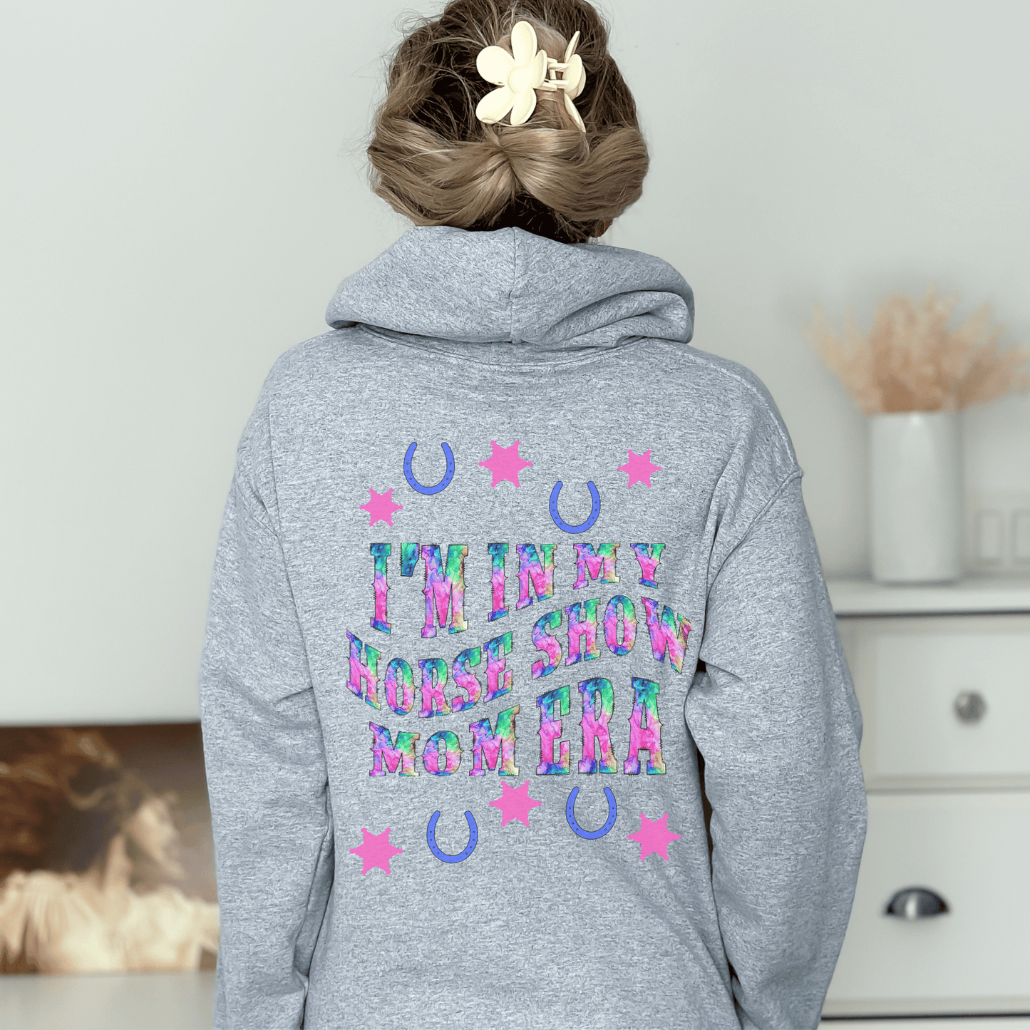 Be stylish while cheering on your equestrian superstar with our Horse Show Mom Era Hoodie. This cozy hoodie features a soft and comfortable fabric that will keep you cozy during those chilly show mornings and evenings.
