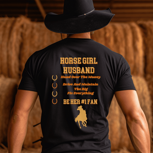 This playful tee showcases the words "Horse Girl Husband" in a stylish font on the back, allowing you to proudly display your role. In addition, the shirt features the phrase "Hand Over the Money, Drive and Maintain the Rig, Fix Everything, and Be Her #1 Fan." This fun and light-hearted design perfectly captures your commitment and love for your wife's passion for horses.