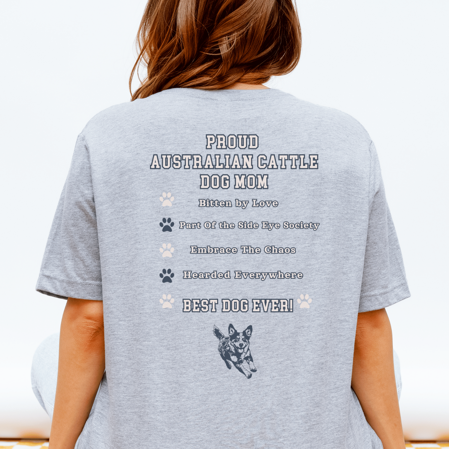 Person wearing a gray t-shirt with text and an Australian Cattle Dog graphic on the back.