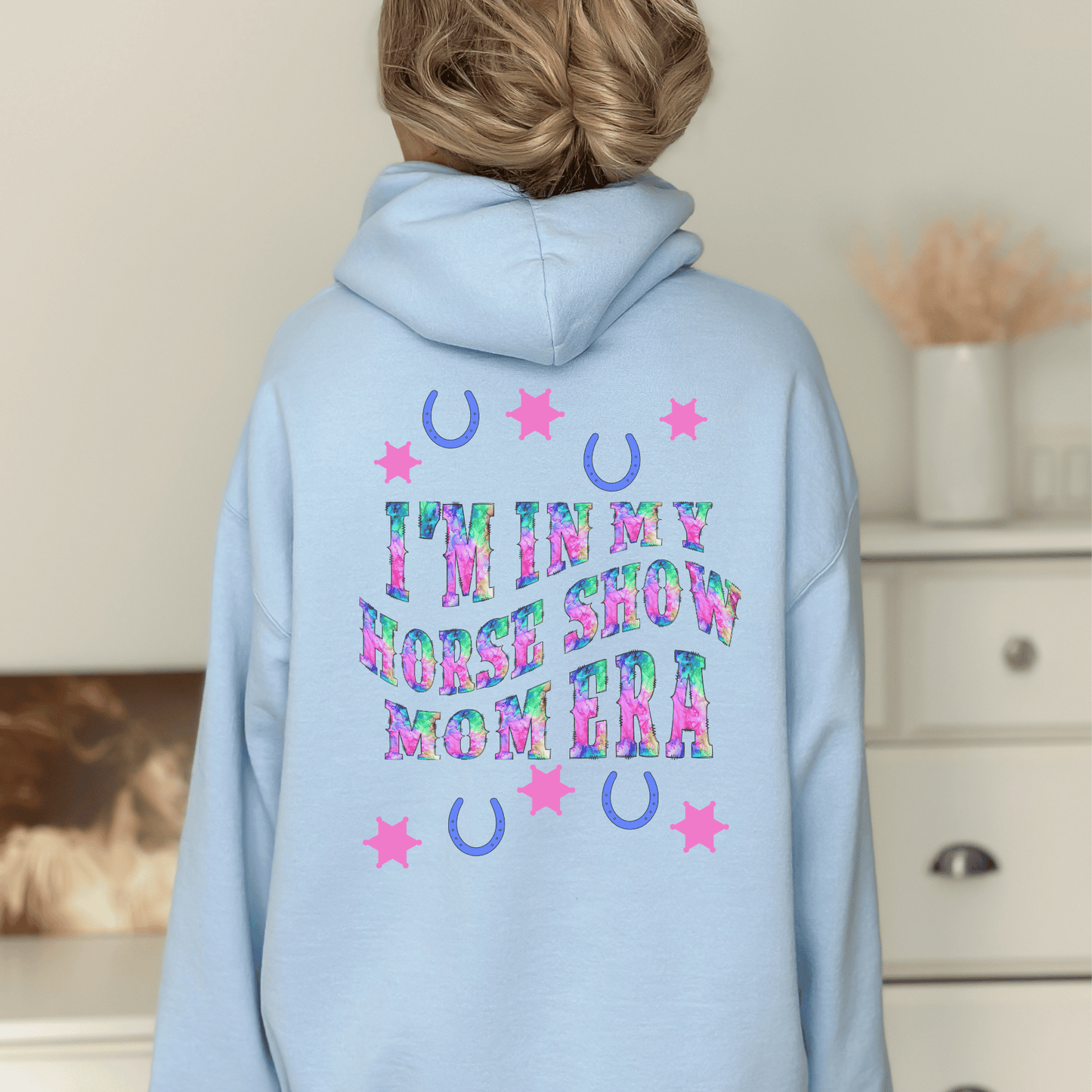 Be stylish while cheering on your equestrian superstar with our Horse Show Mom Era Hoodie. This cozy hoodie features a soft and comfortable fabric that will keep you cozy during those chilly show mornings and evenings.